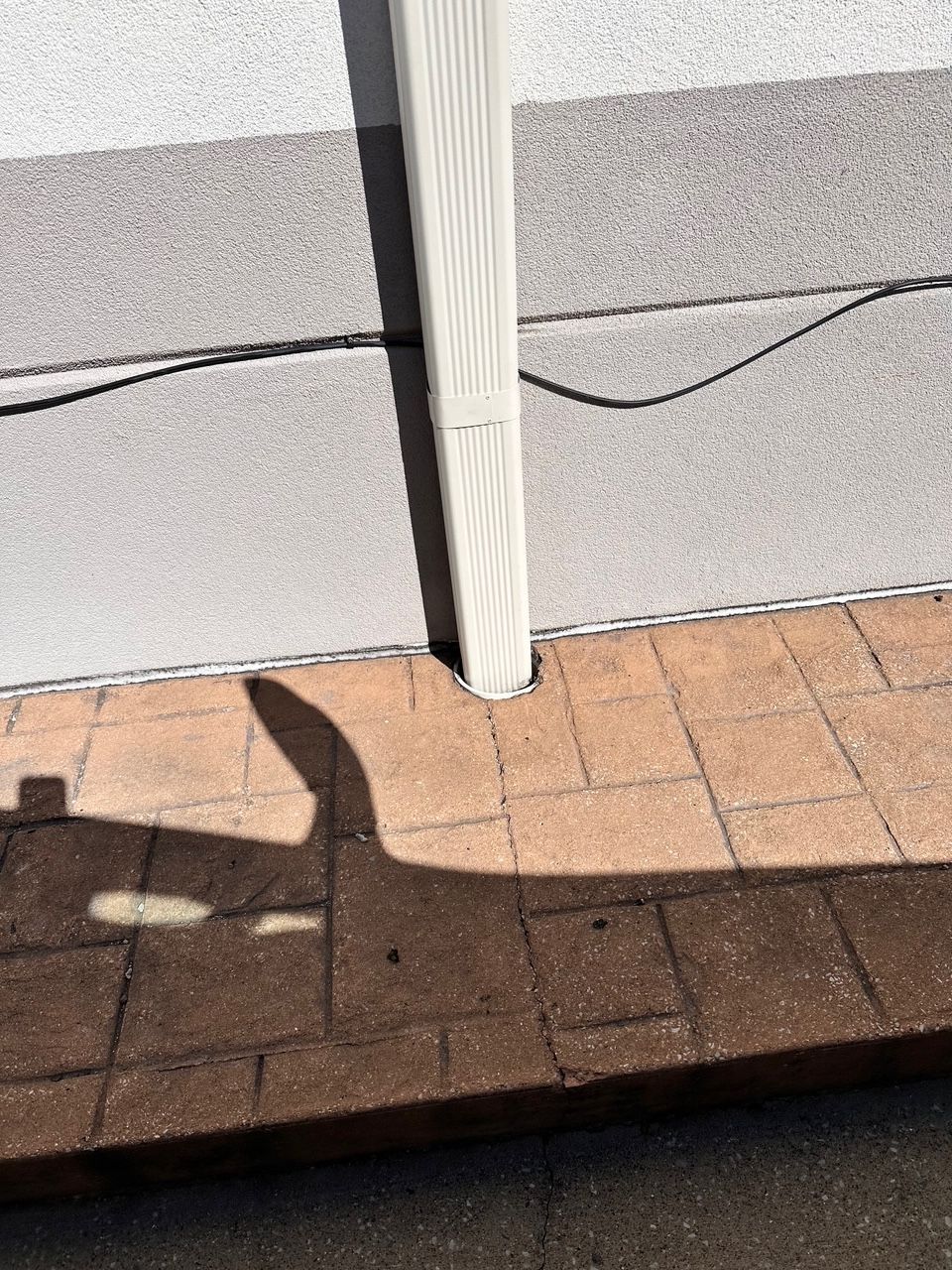 A downspout has been installed along the building's exterior.