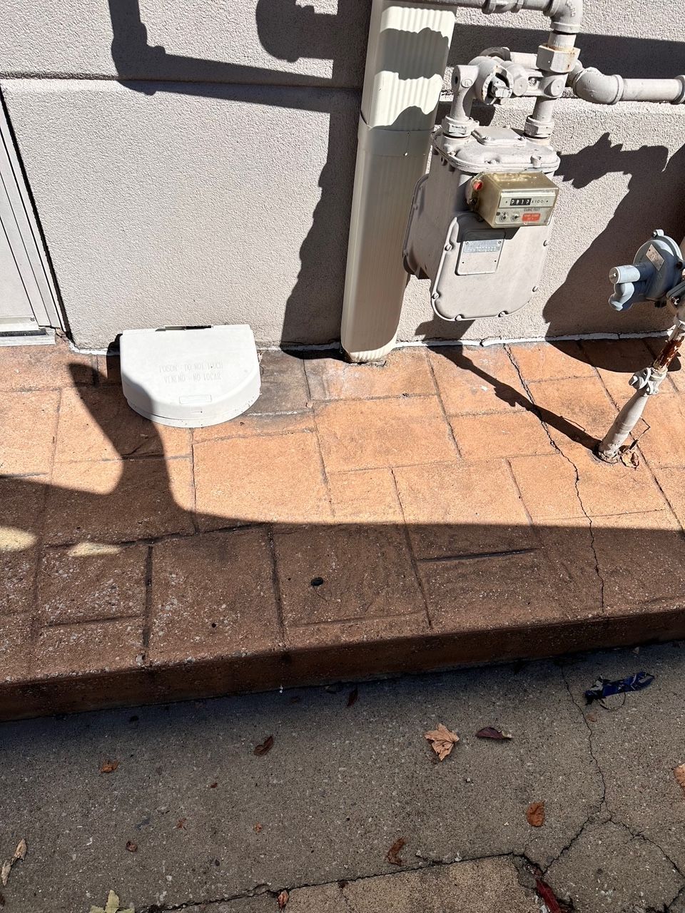 A downspout has been installed along the building's exterior.
