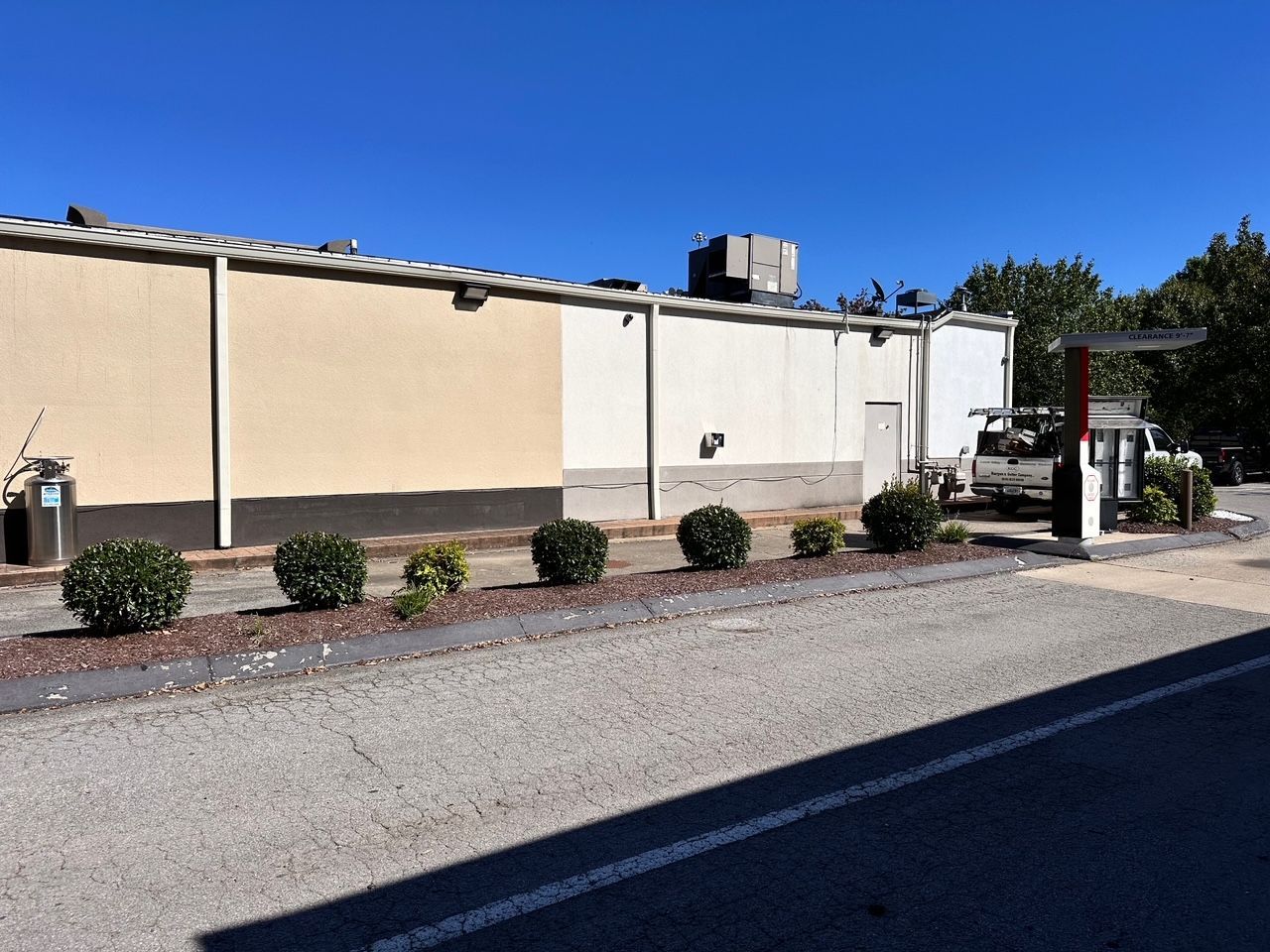 A building with a properly installed gutter and downspout system.