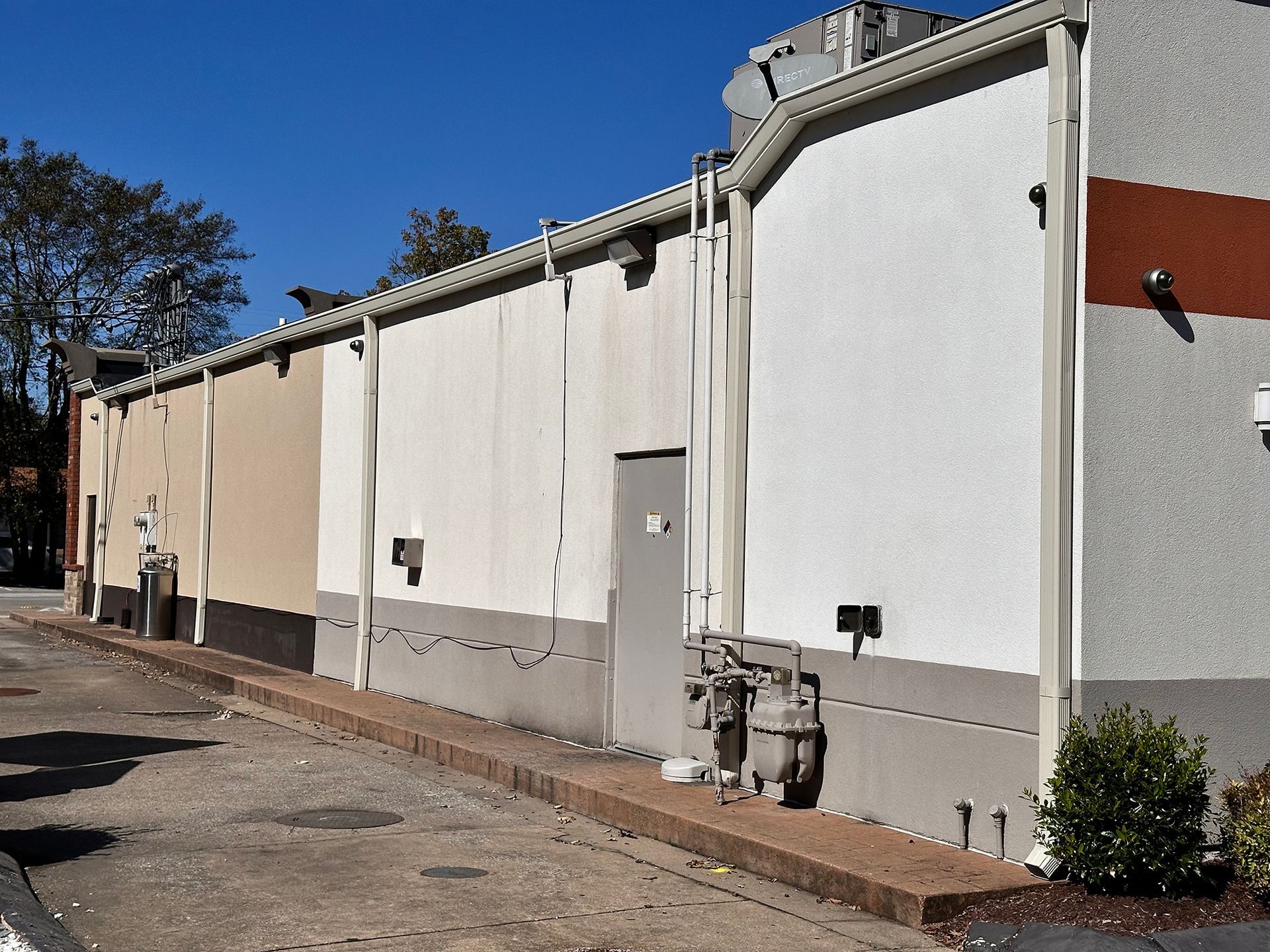 A commercial property with a well-installed gutter and downspout system.