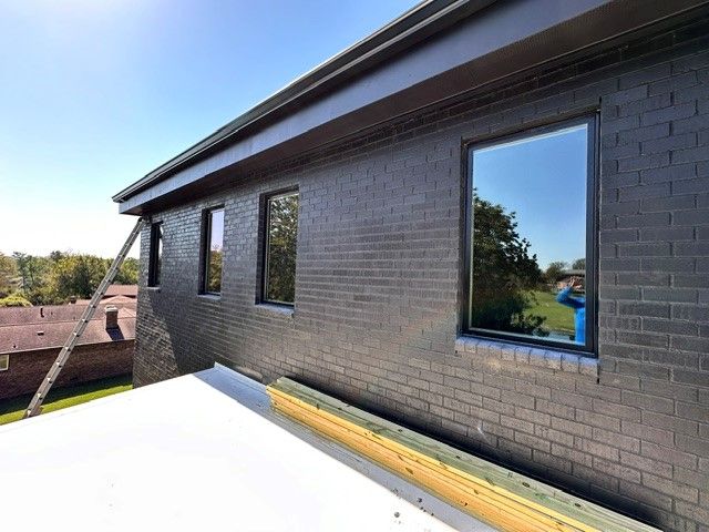 The gutter system of a house is currently being repaired.