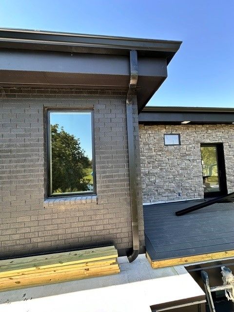 The gutter system of a house is currently being repaired.