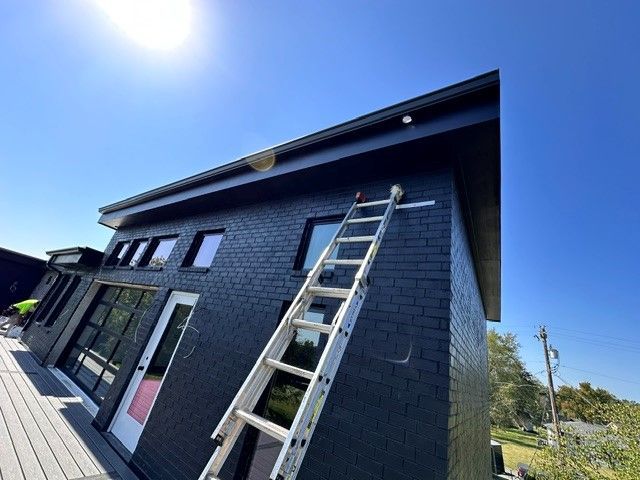 The gutter system of a house is currently being repaired.