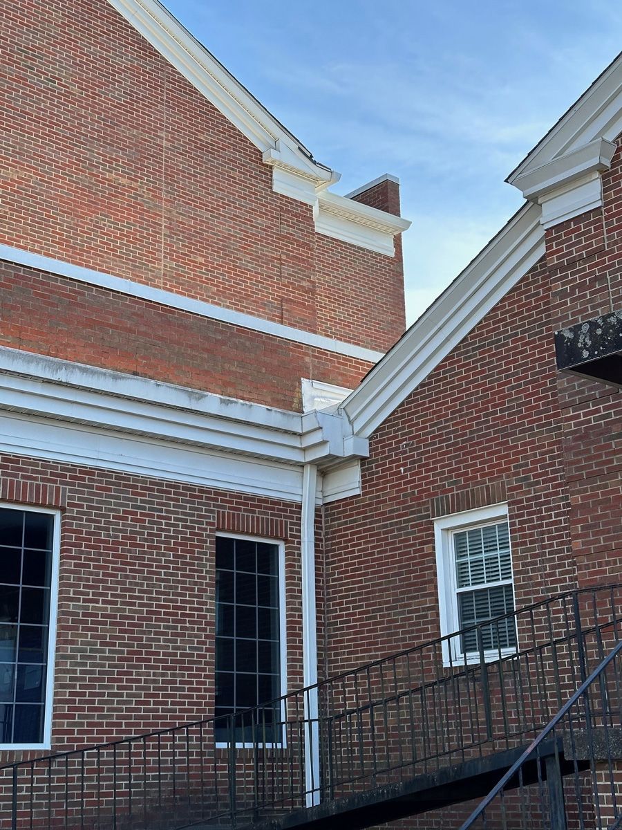 A brick building with stairs leading up to it