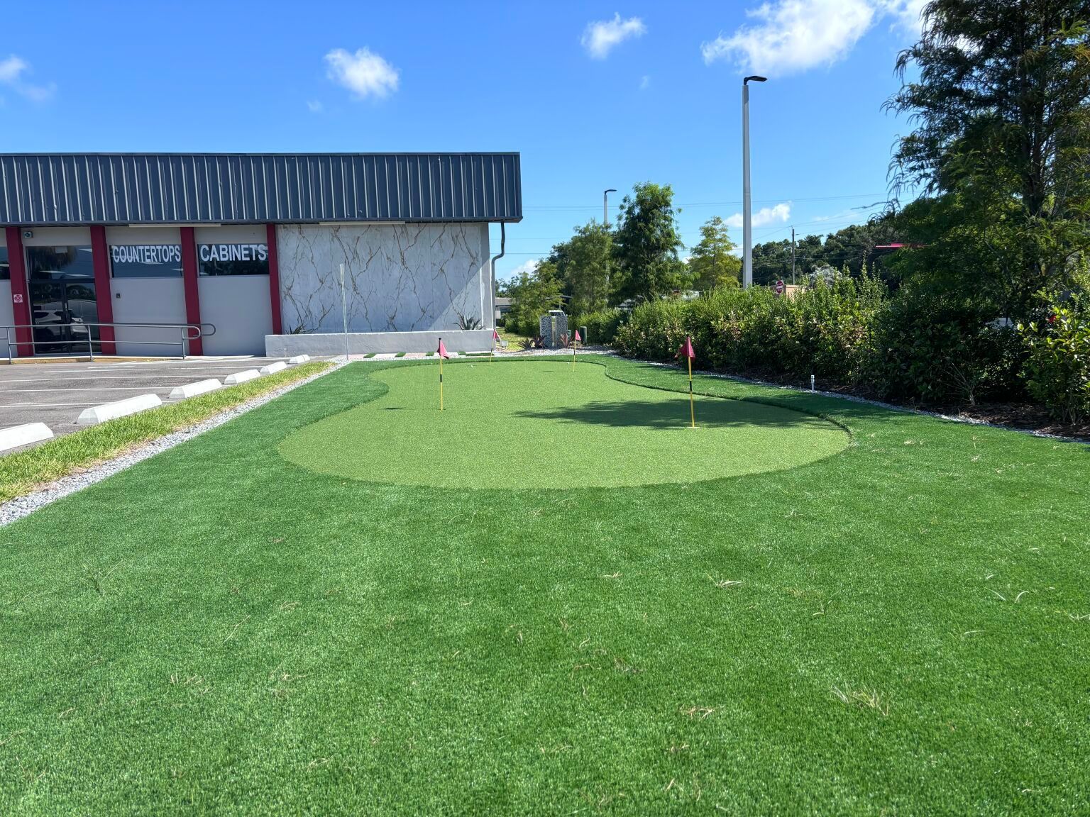 A small putting green in front of a building
