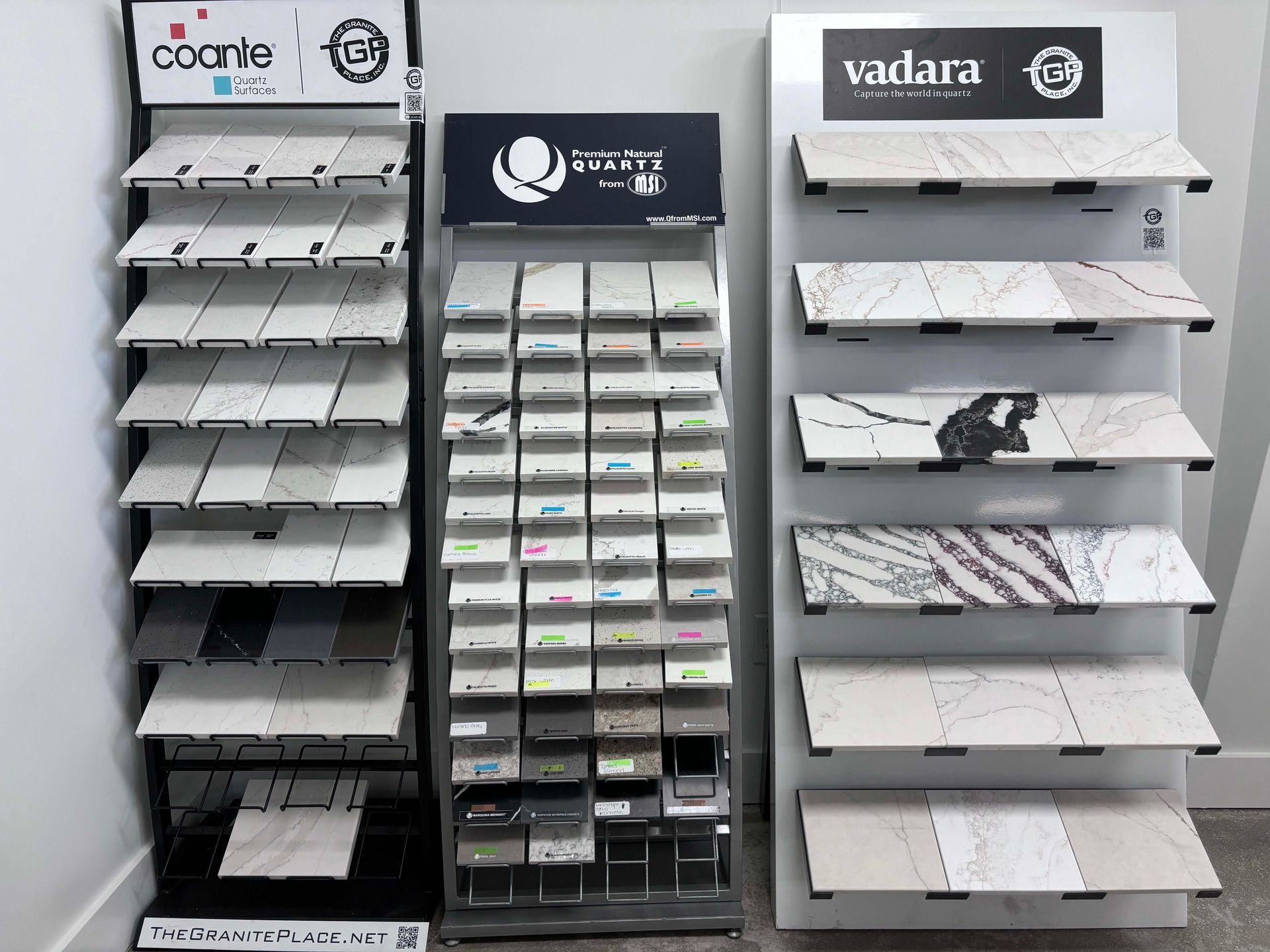 Three shelves filled with different types of tiles in a store.