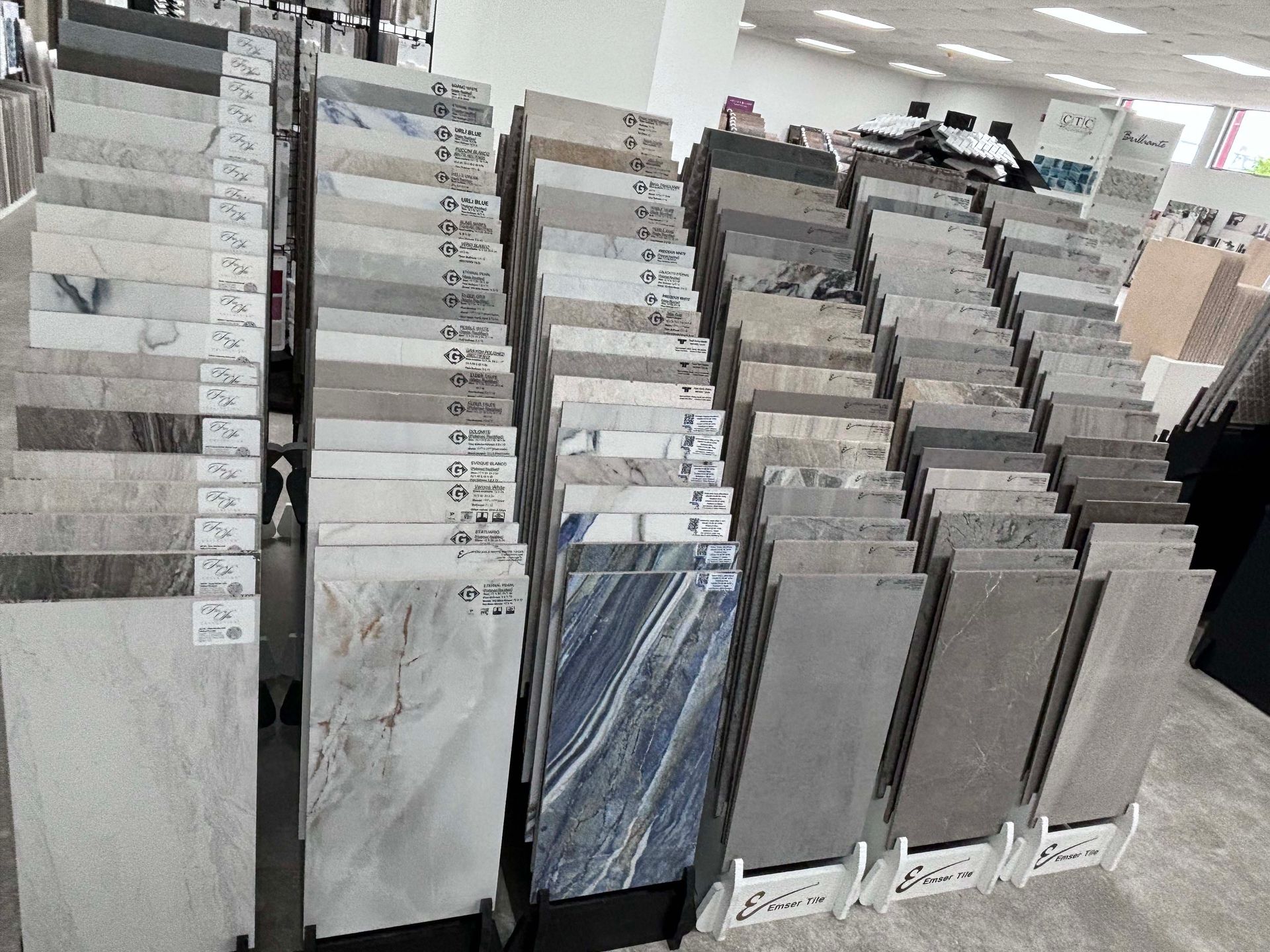 There are many different types of tiles on display in a store.