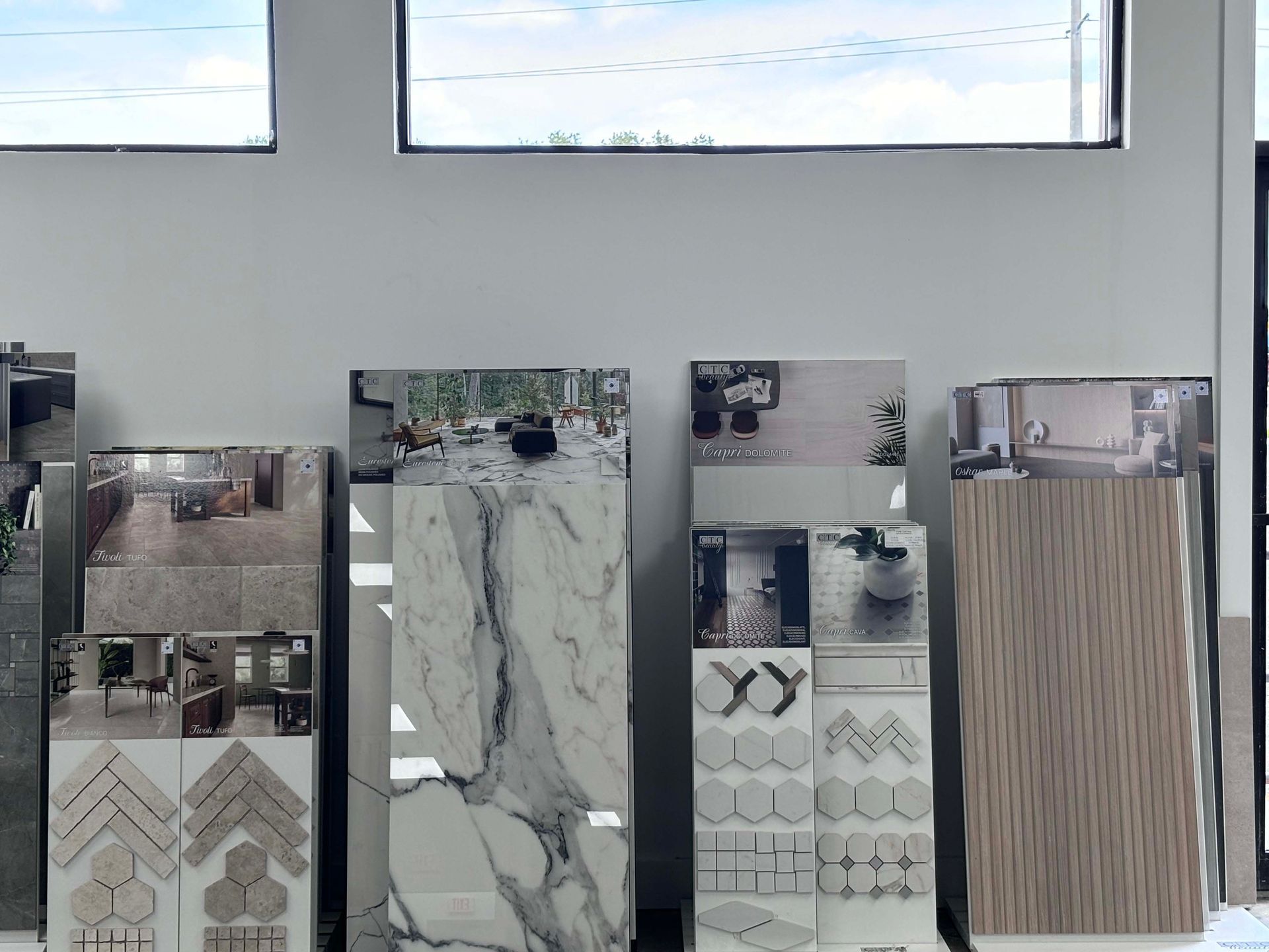 A room with a lot of tiles on display and a window
