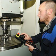 A technician working with a CNC milling machine