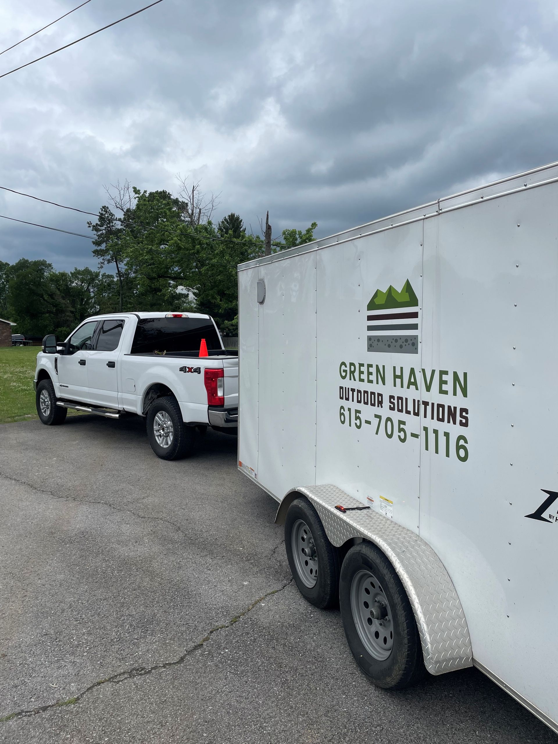 A white truck is towing a white trailer.