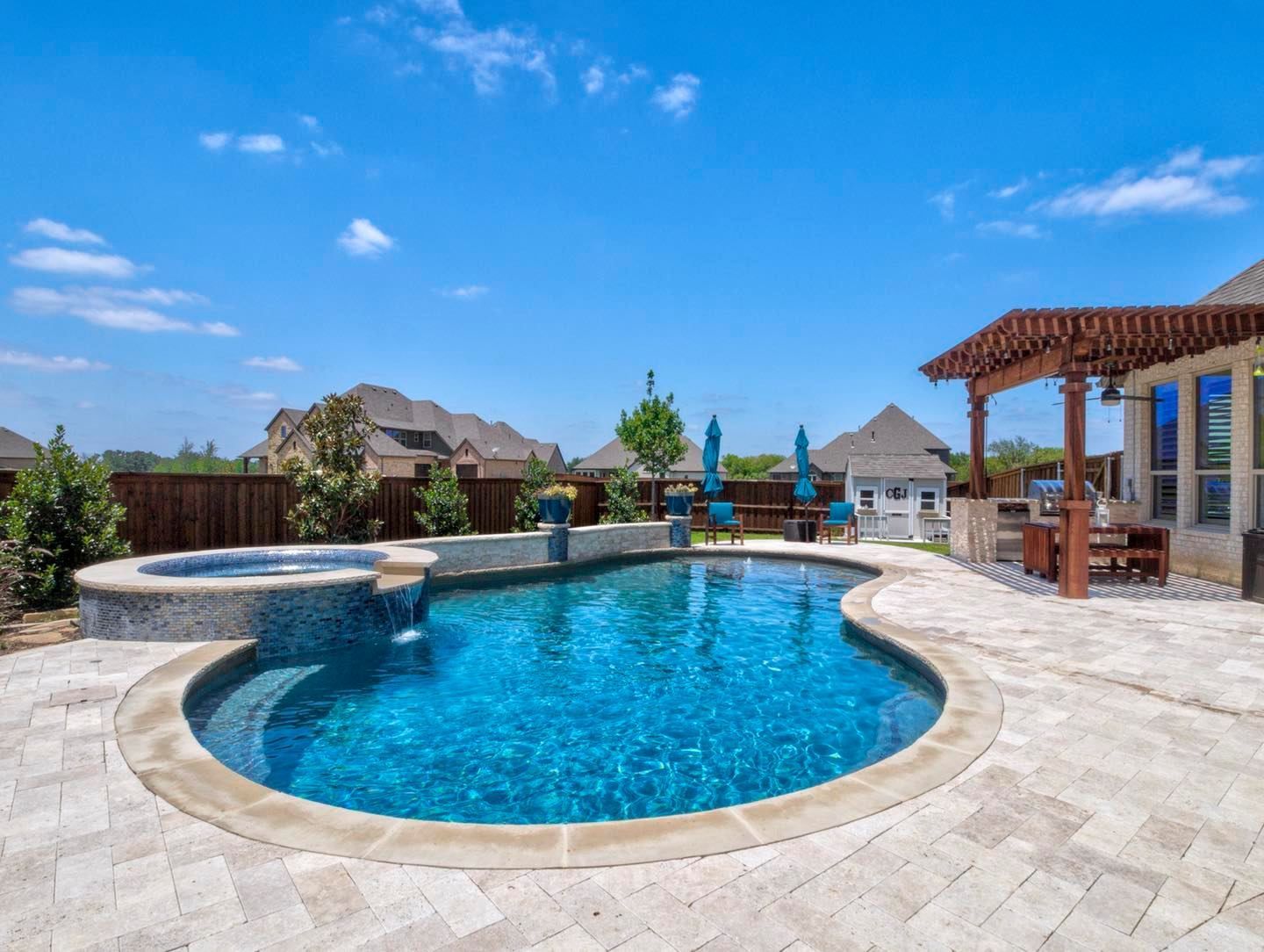 A large swimming pool in the backyard of a house