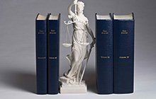Law books and a justice statue