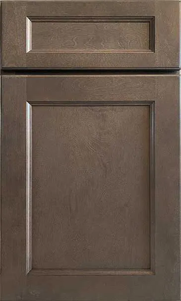 Brown cabinet door with a raised panel and a smaller rectangular panel at the top.