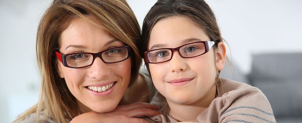 Women and a kid in glasses