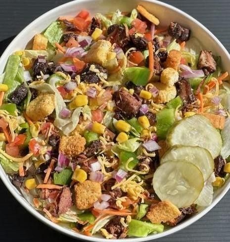 A bowl of salad with a lot of vegetables in it