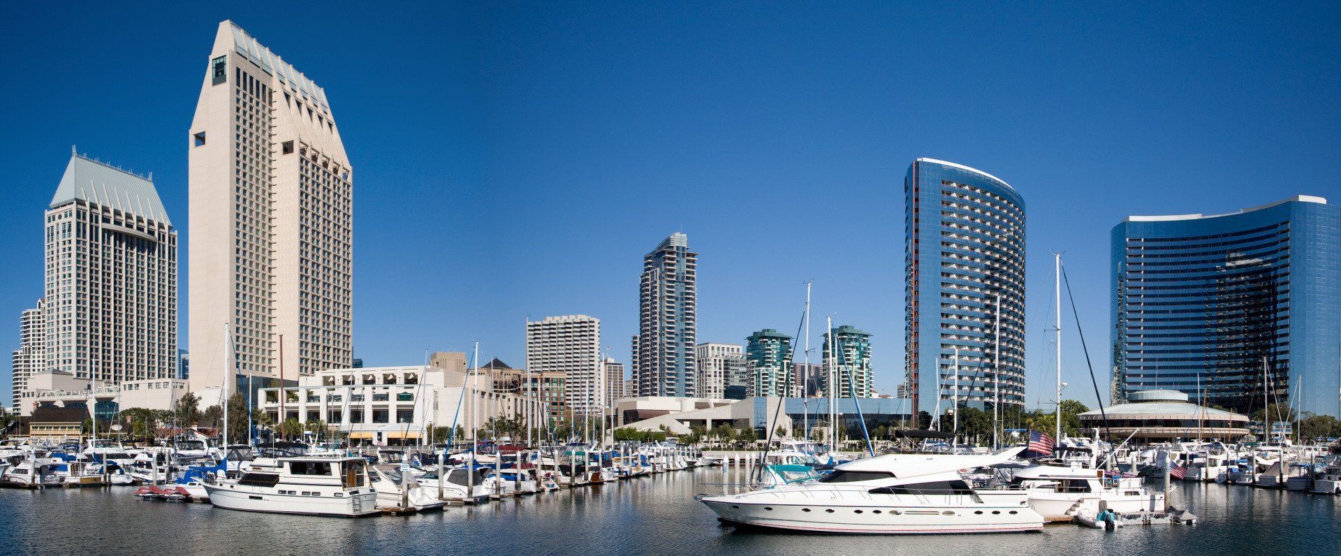 A city skyline with boats docked in the foreground