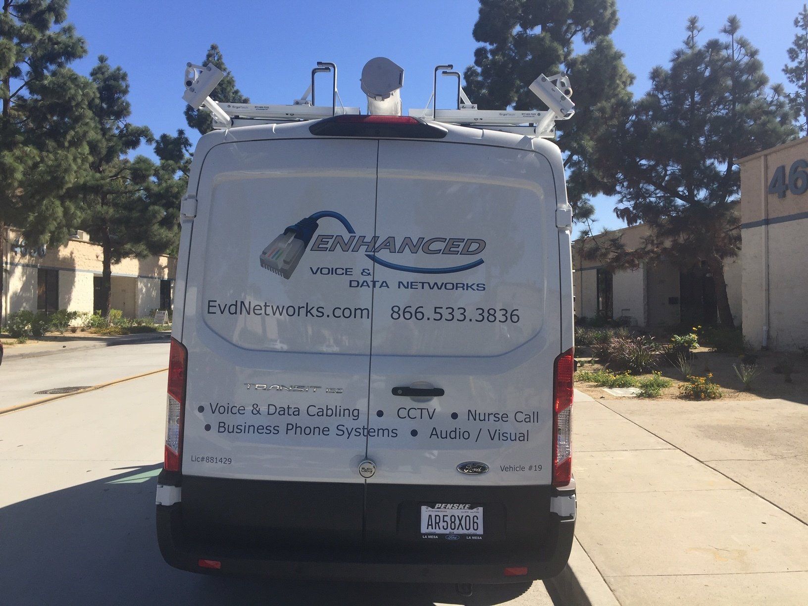 A white van with the word enhanced on the back