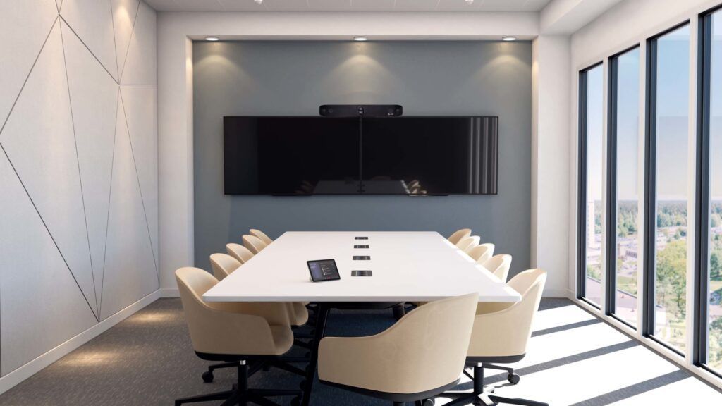 A conference room with a long table and chairs and a flat screen tv on the wall.