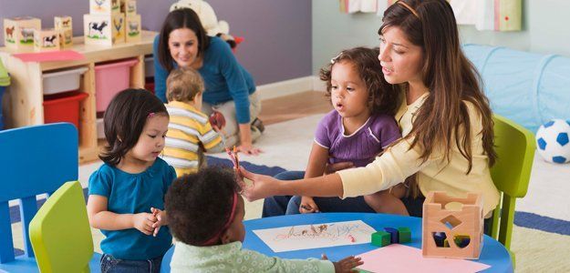 Energetic staff caring for toddlers