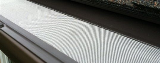 A close up of a window sill with a carpet on it.