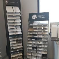 A kitchen with a large island and a marble wall