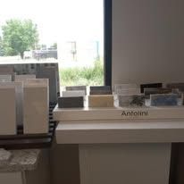 A table with a lot of tiles on it in front of a window.