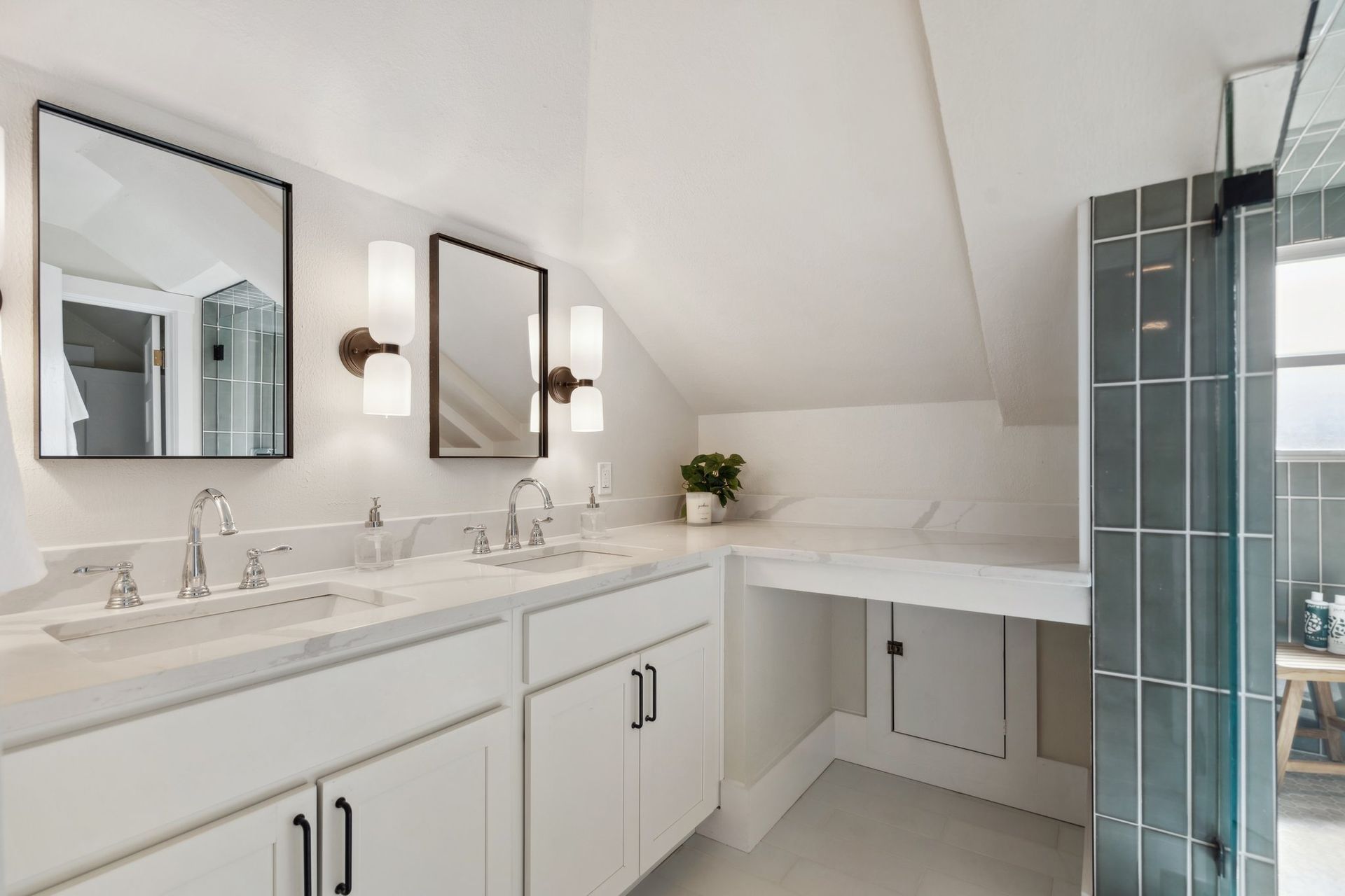 A bathroom with two sinks and two mirrors