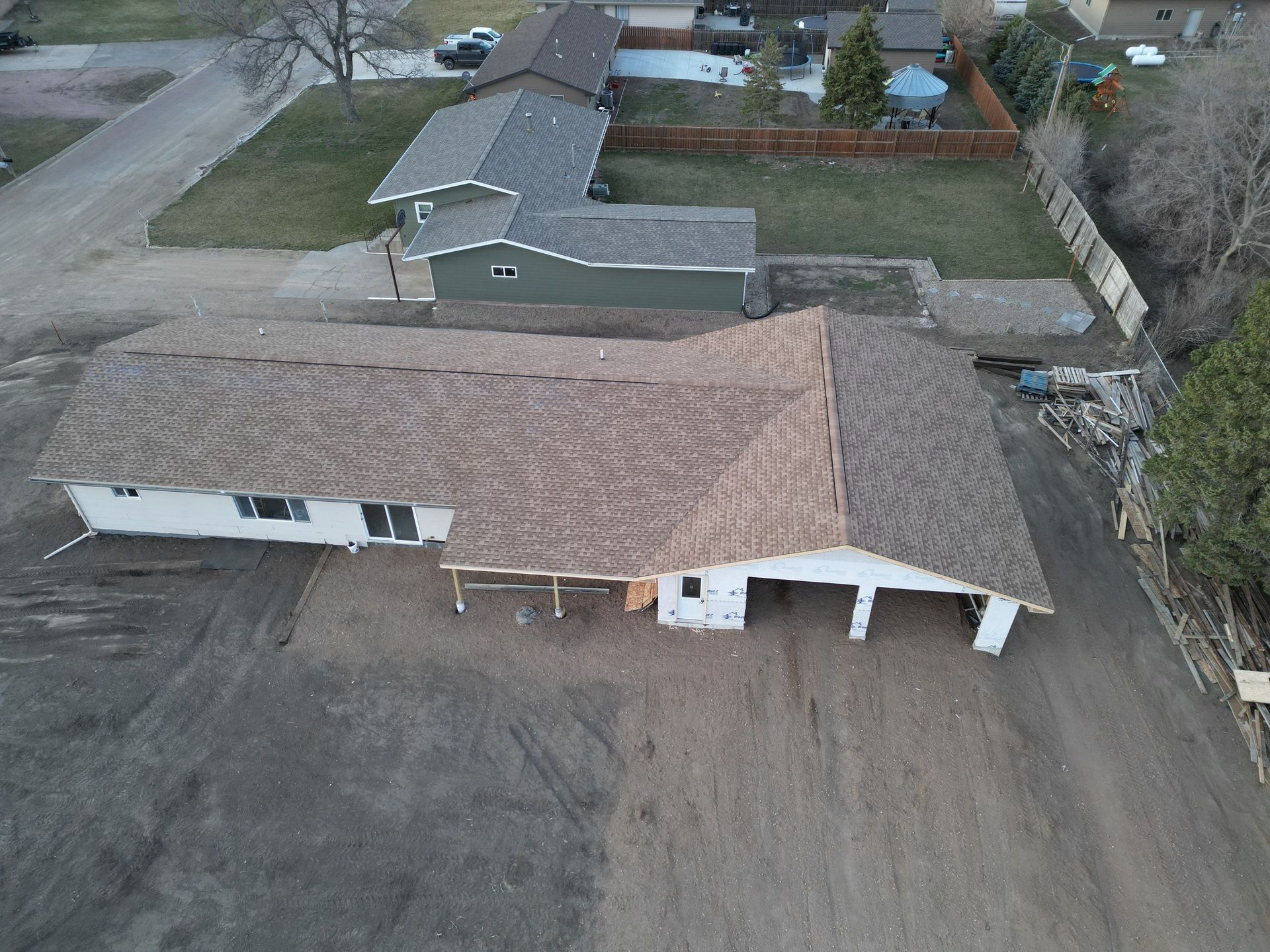 An aerial view of a house under construction with a brown roof