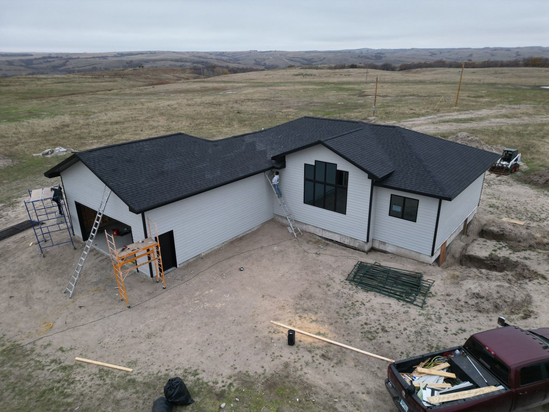 An aerial view of a house under construction with a truck parked in front of it.