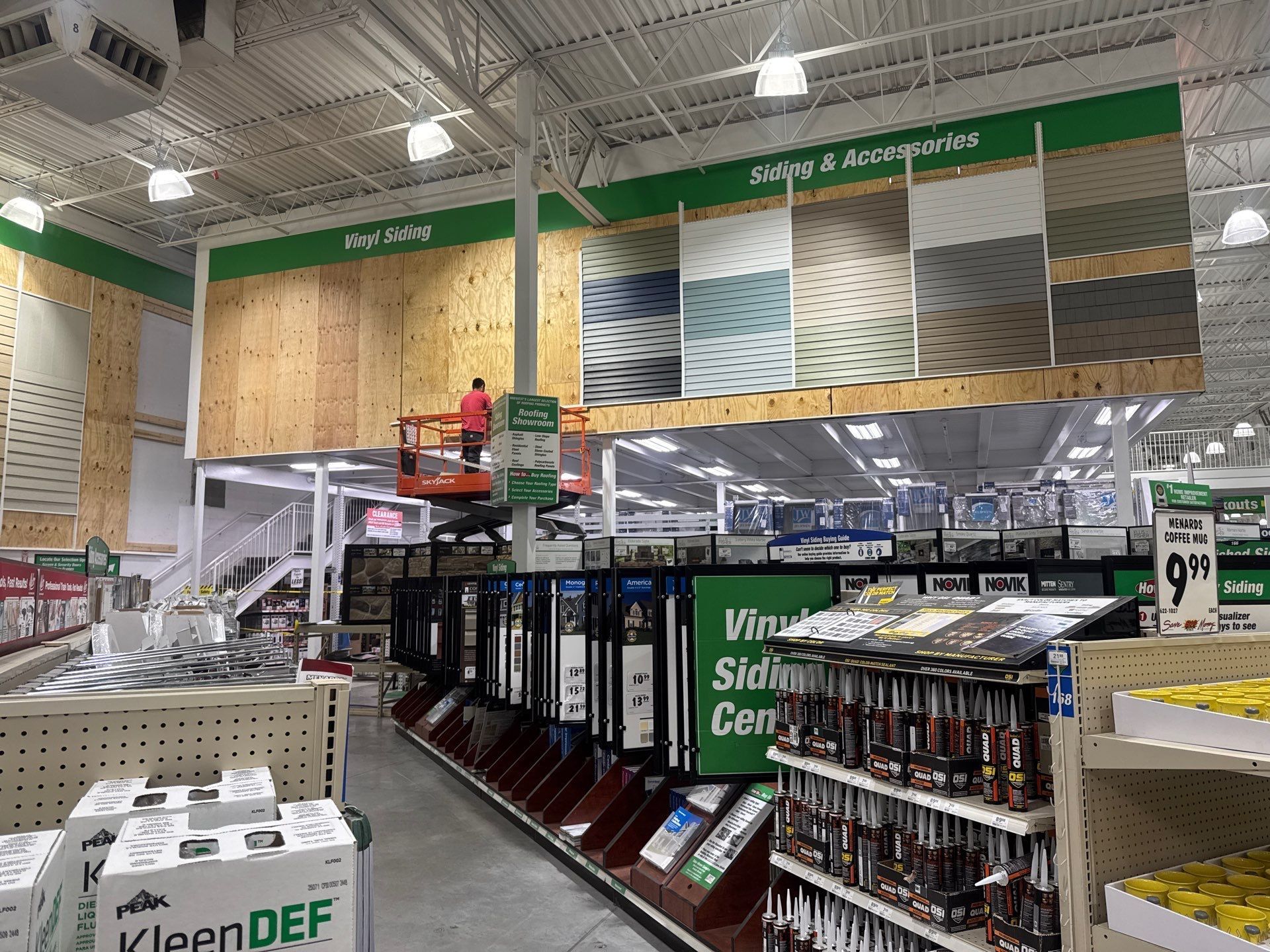 A man is working on a lift in a hardware store.