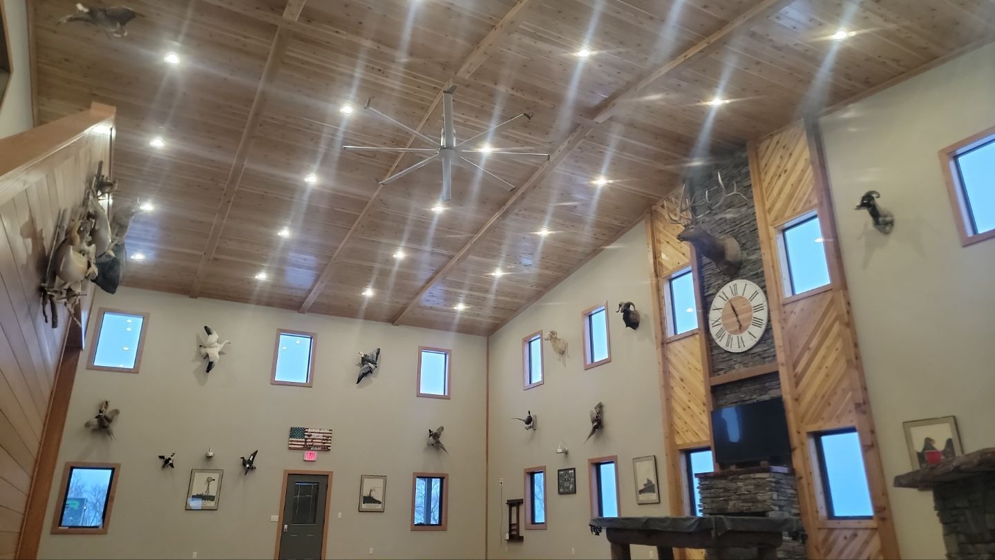 A large room with a fireplace and a clock on the wall.