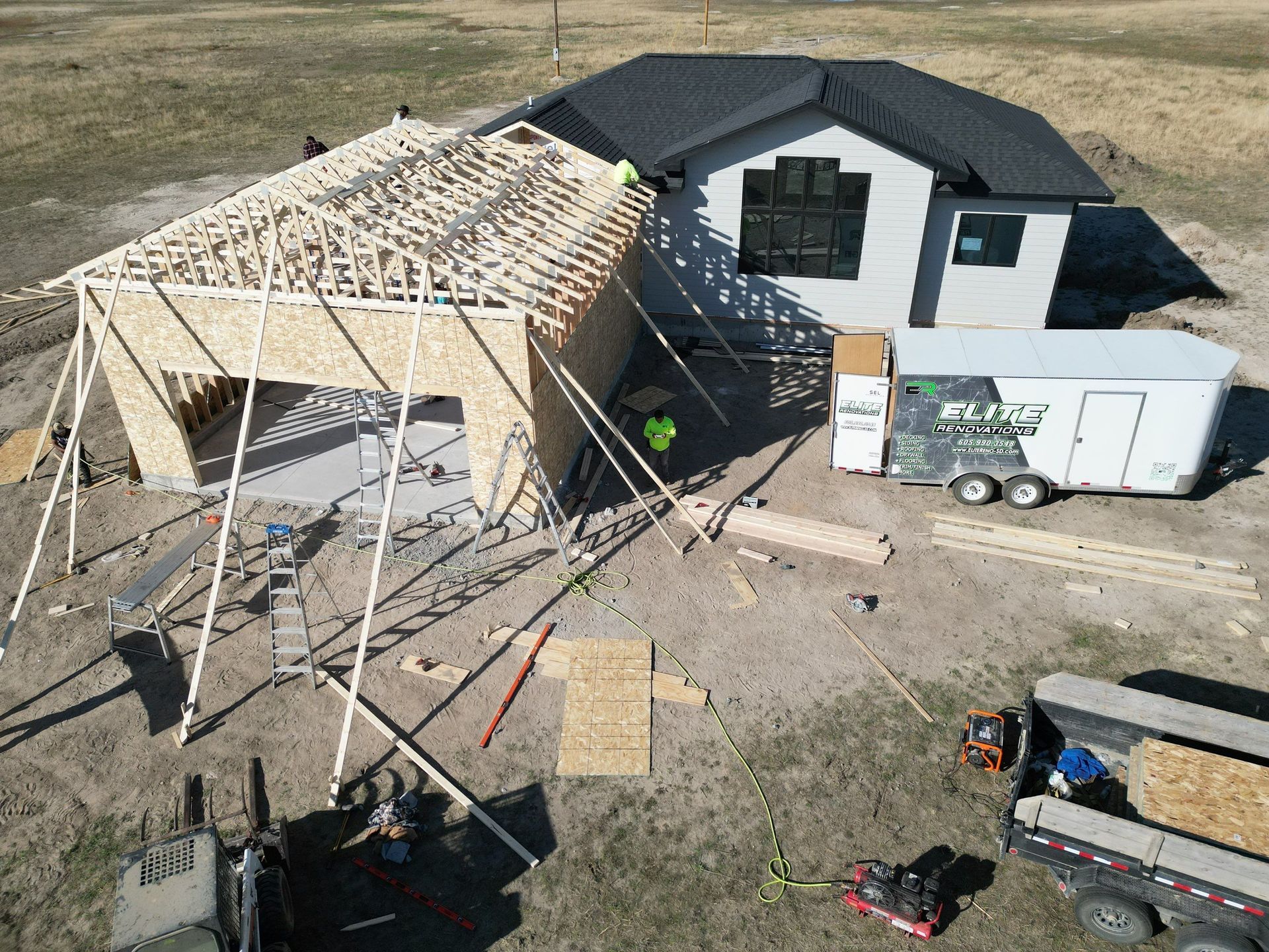 An aerial view of a house under construction in a field.