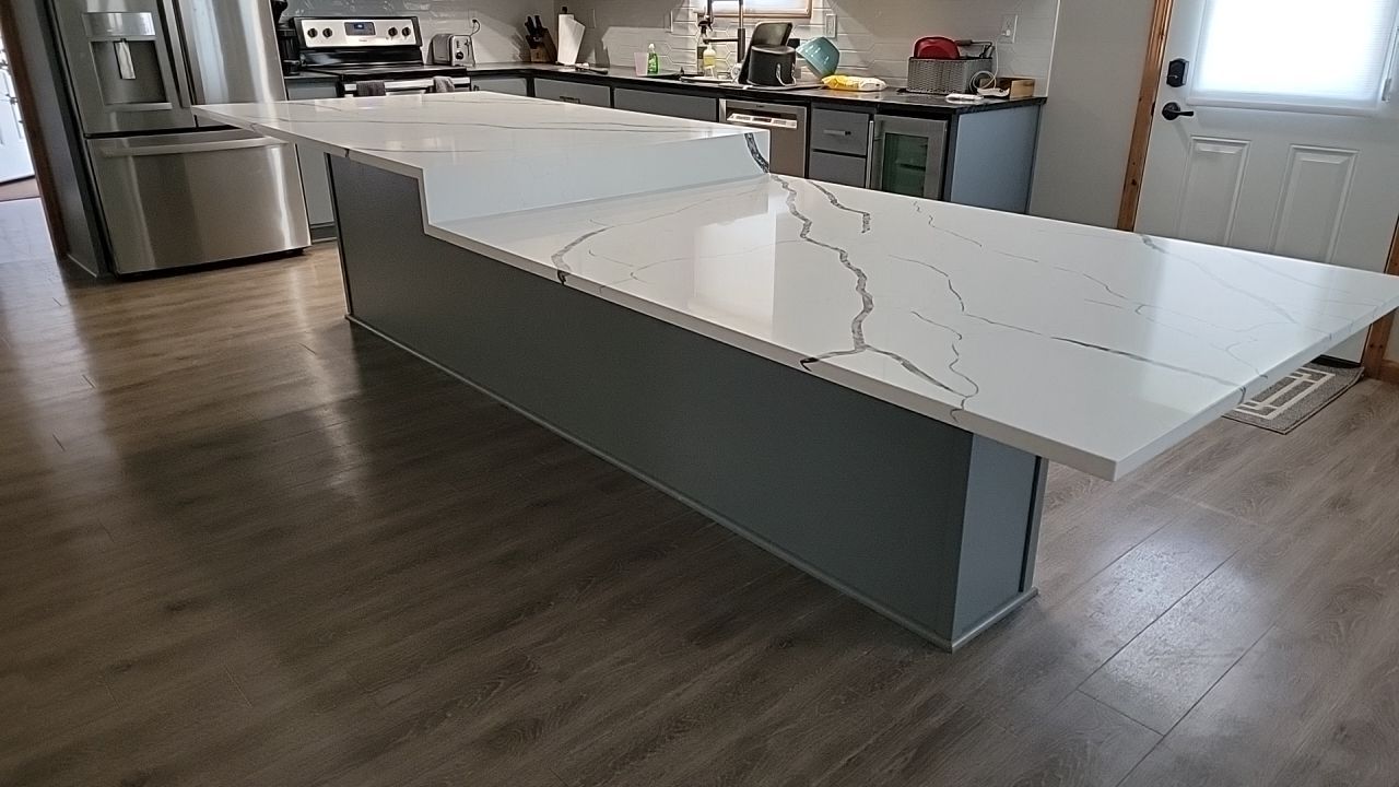 There is a large island in the middle of the kitchen.