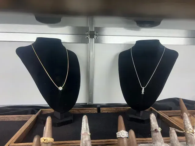 Two mannequins with necklaces and rings on them