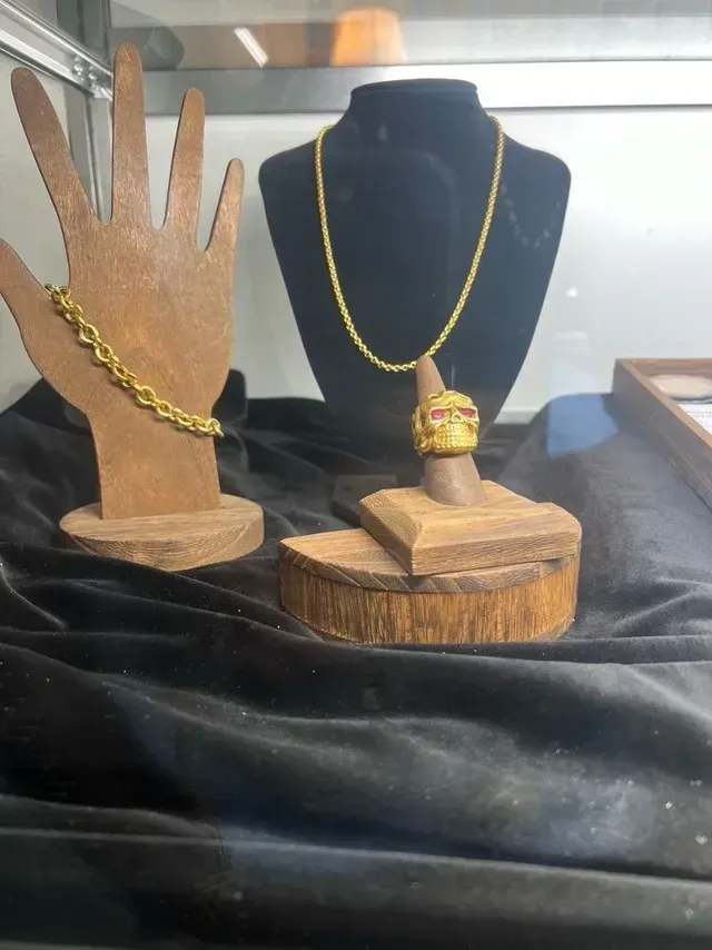 A necklace and a ring are on display on a table