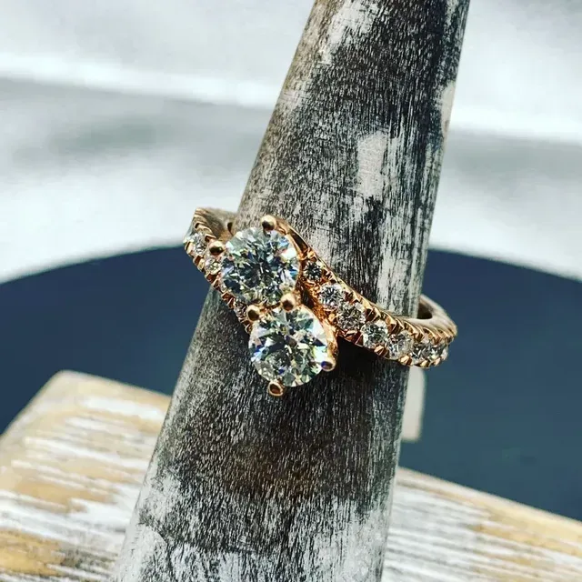 A ring sitting on top of a wooden ring holder