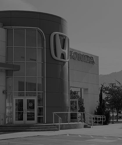 a black and white photo of a Honda dealership