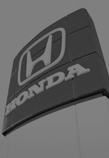 a black and white photo of a Honda sign