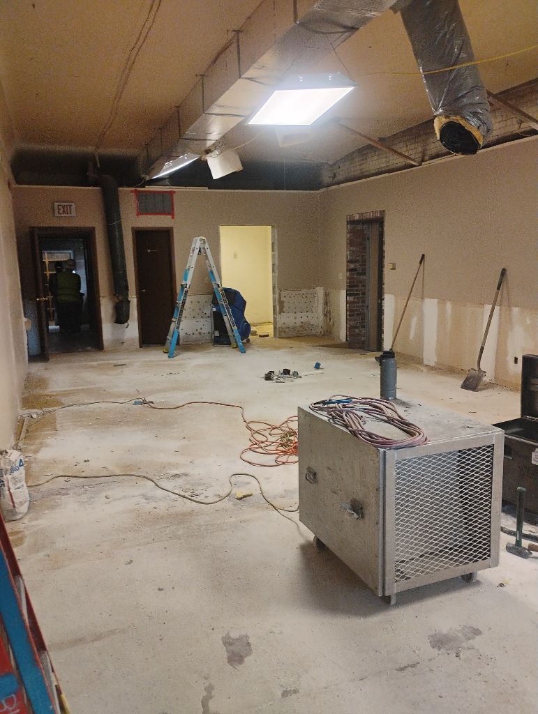 Renovation in a building interior, with exposed walls, tools, and machinery.