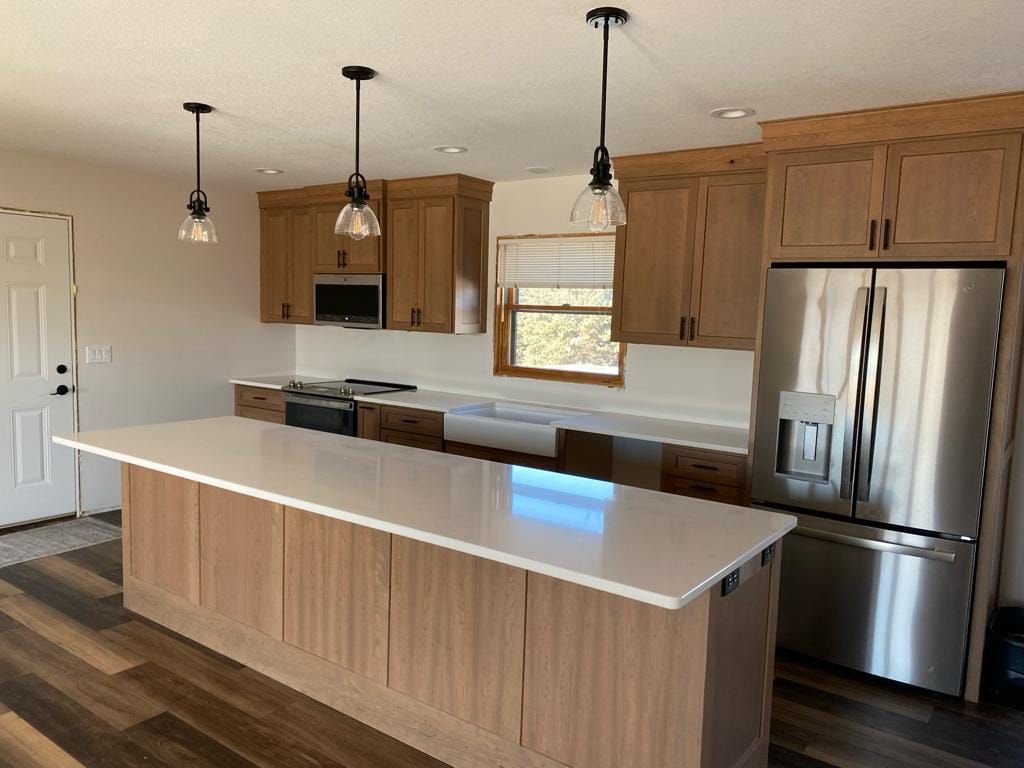 A kitchen with stainless steel appliances and wooden cabinets