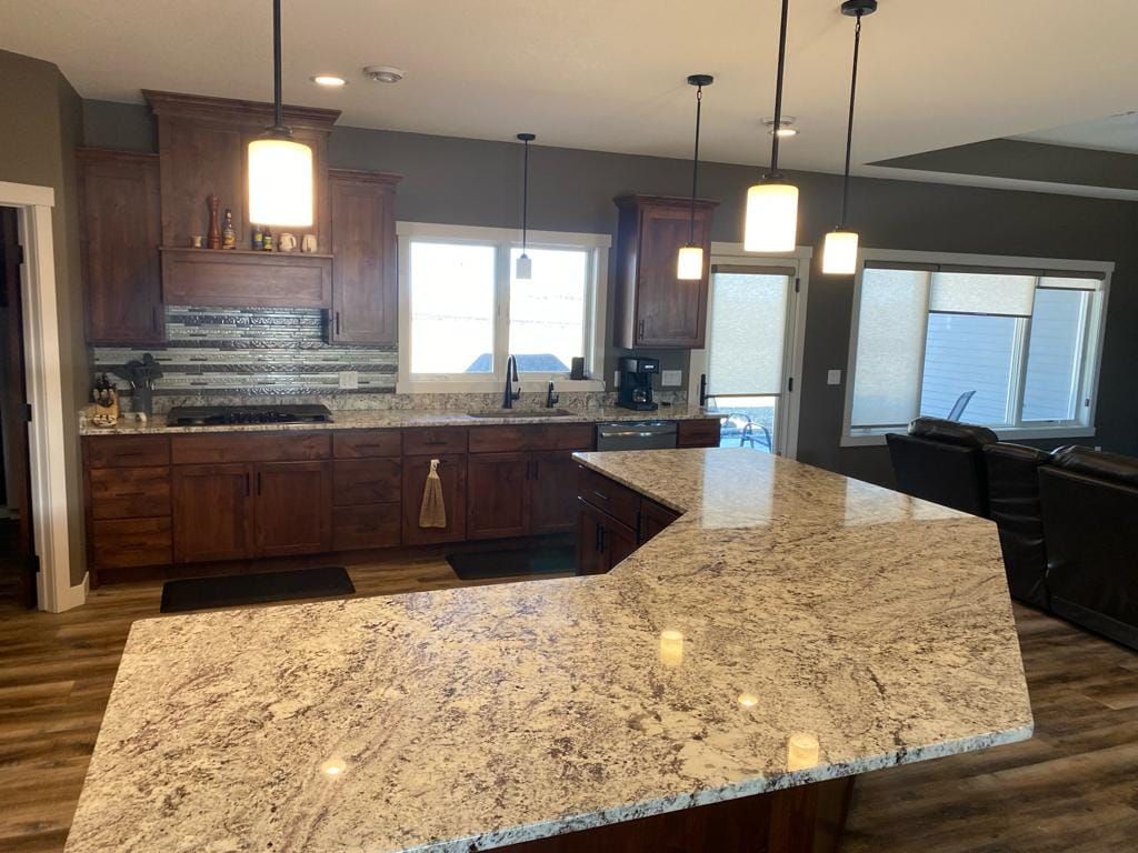 A kitchen with granite counter tops and wooden cabinets