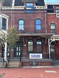 A large brick building with a sign on the front of it.