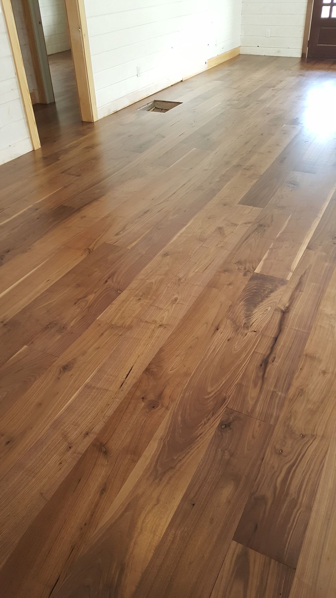 A room with a wooden floor and a hole in the floor.