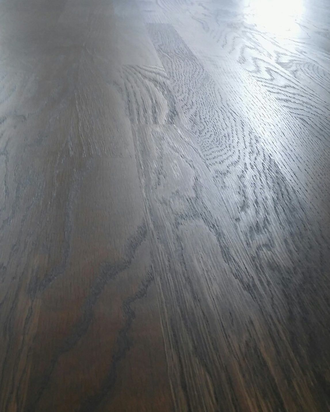 A close up of a wooden floor with a light shining on it.