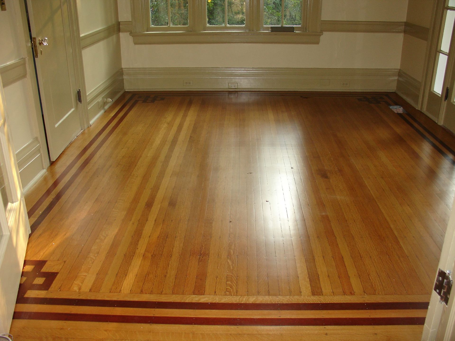 A room with a wooden floor and a window.