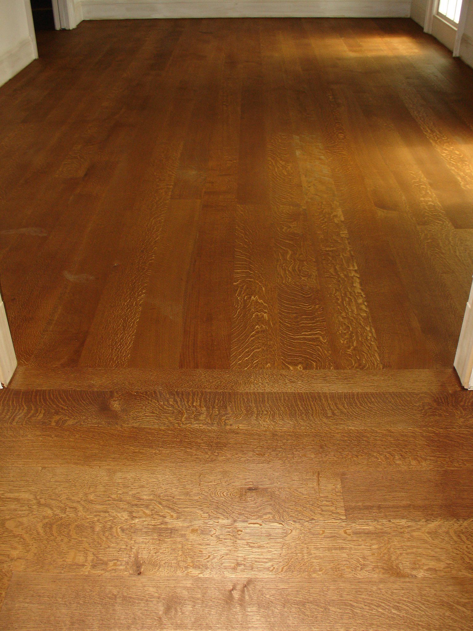 A room with a wooden floor and a window.