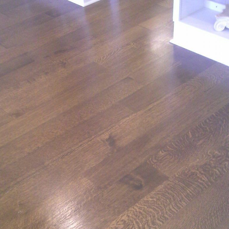 A close up of a wooden floor in a room.