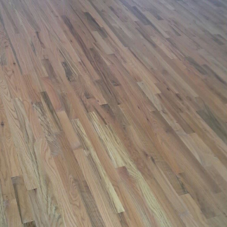 A close up of a wooden floor in a room.