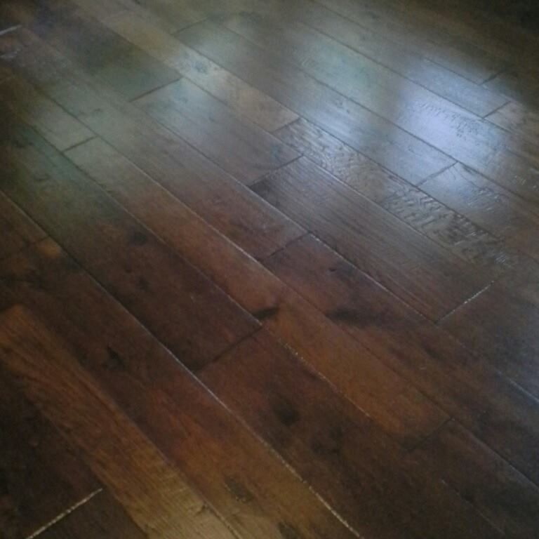 A close up of a wooden floor in a room.