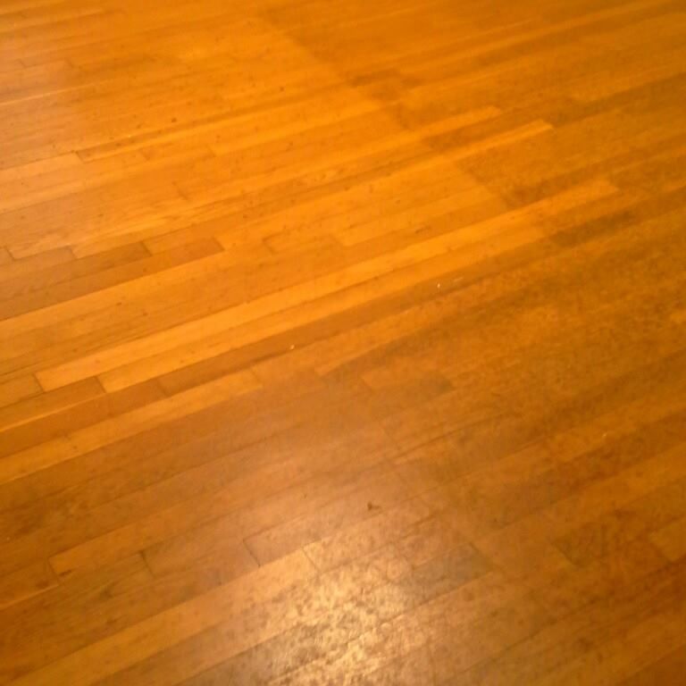 A close up of a wooden floor in a room.